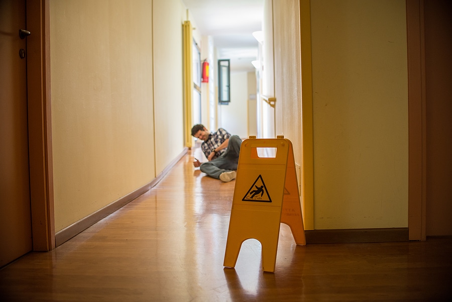 Man Slips On Wet Floor Wet Floor Danger Sign In The Foreground